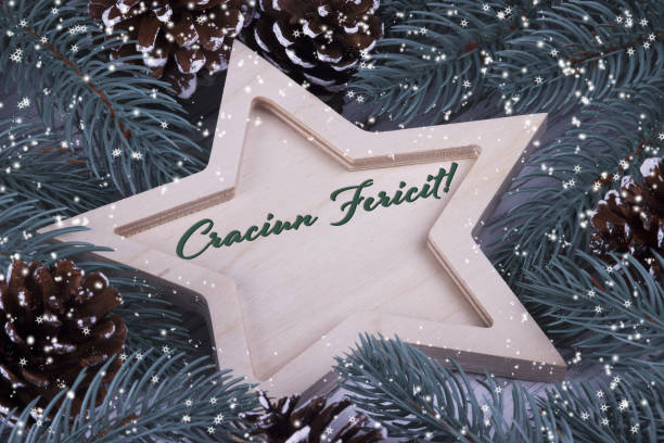Christmas Xmas New Year Holiday greeting card with wooden five pointed star fir branches cones and text Craciun Fericit