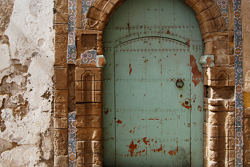 Traditional turquoise riad door in medina, Morocco