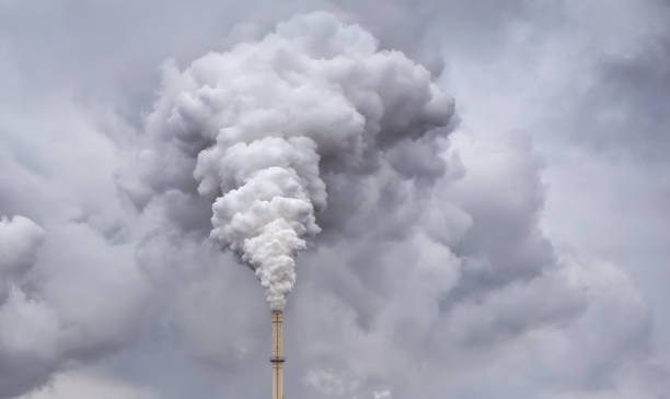 istock Smoke from factory pipe against dark overcast sky 866725950