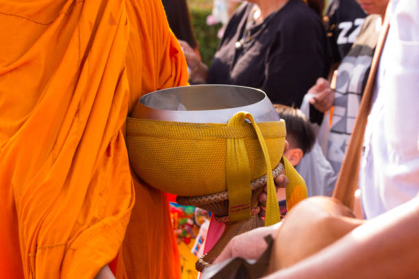 istock People give food offerings to Buddhist monks 866726094