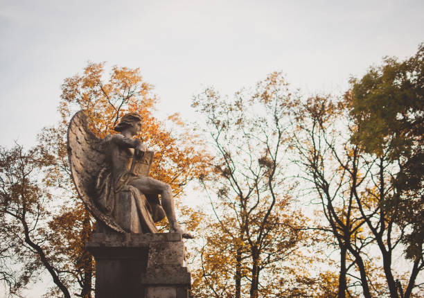 istock Abandoned old statue of an angel against yellow trees 866735576