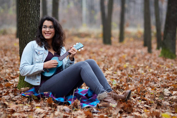 istock Latino girl playing ukulele 866739374