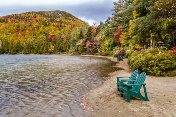 istock Fall foliage at the lake with Adirondack chairs 866742314