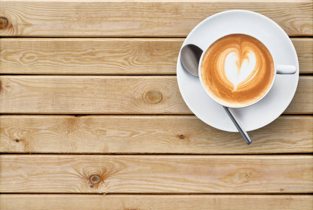 Coffee with heart saucer on a wooden background