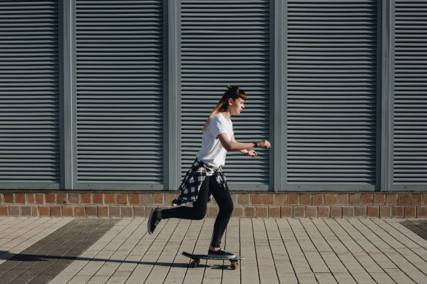 istock Hipster girl riding skate board 866757916