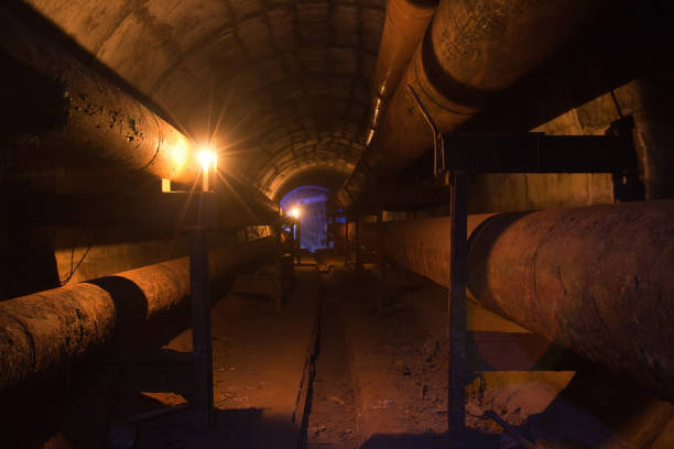 istock Round underground tunnel of heating duct with rusty tubes 866758080