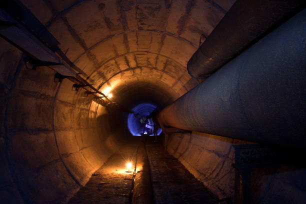 istock Round underground tunnel of heating duct with rusty tubes 866758108