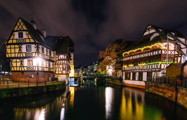 Petite-France water canals in historic area of Strasbourg, France Traditional Alsatian half-timbered houses with christmas ornates in Petite France with mirror reflections during Noel night, Strasbourg, Alsace, France La Petite France stock pictures, royalty-free photos & images