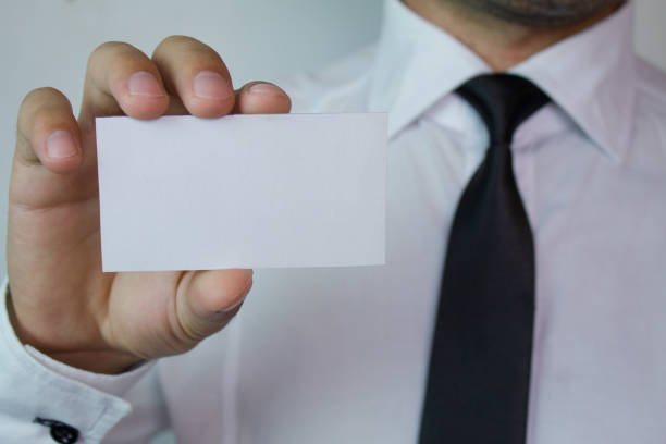 istock Businessman showing a business card. 866763908