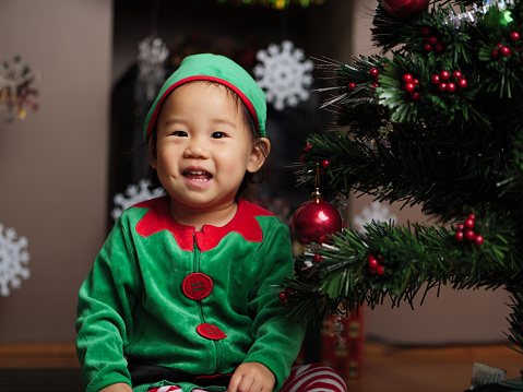 baby girl  decorating Christmas tree