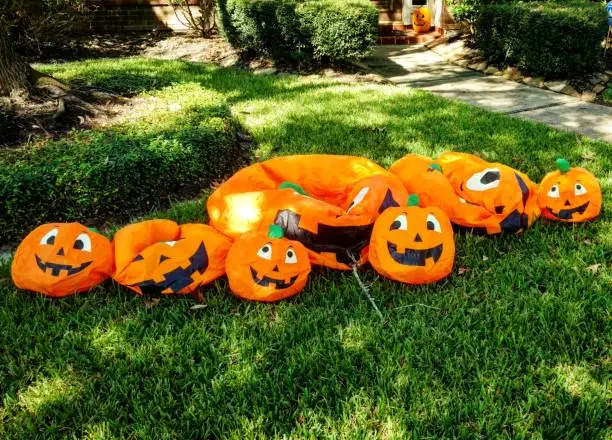Cheerful inflatable Halloween decorations of jack-o'-lanterns have lost their air and deflated on a suburban house's front lawn in the Houston suburb of Clear Lake, Texas.