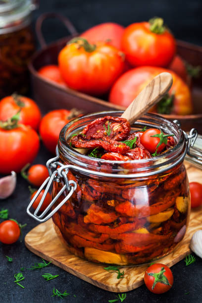 istock Sun dried tomatoes with garlic and olive oil in a jar 866779730