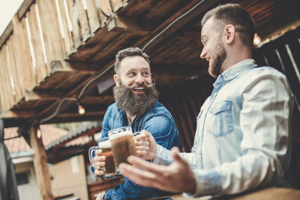 istock Two Smiling Bearded Man Drinking Beer and Having a Great Time 866782650