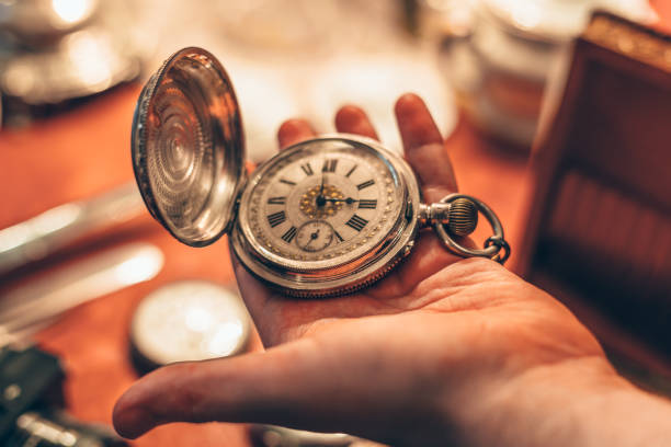 istock Ancient vintage pocket clock in man hand 866785942