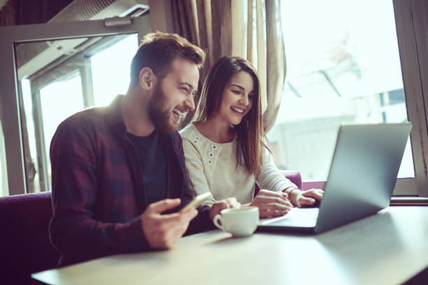 istock Smiling Couple Drinking Coffee and Making Video Conference in the Morning 866788748