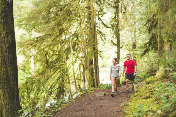 istock Couple running in the forest 866795310