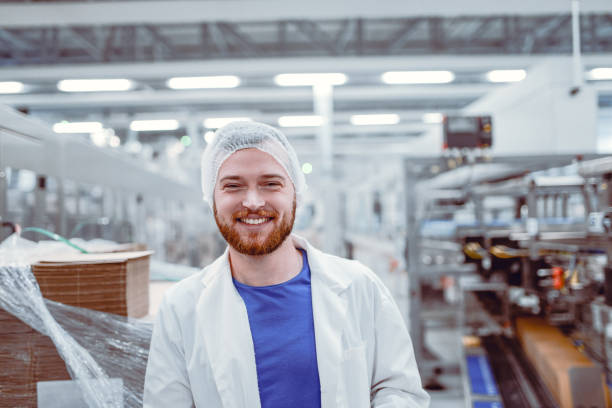 istock Young Smiling Scientist Posing in Modern Factory 866796294