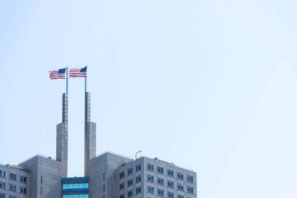 istock Two American flags on a top of a building. 866796776