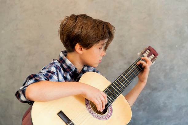 istock Teen boy playing acoustic guitar 866802680