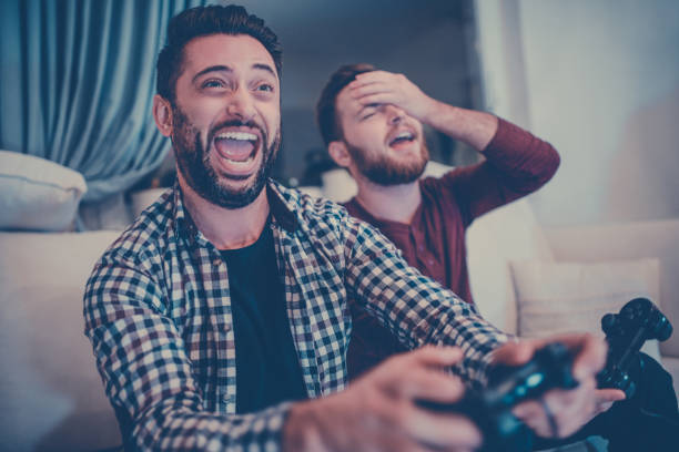 istock Handsome Man Is Defeating His Younger Brother in Video Games 866806536