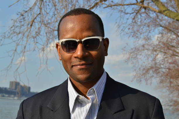 istock Model smiling; wearing a collared dress shirt and shades 866825886