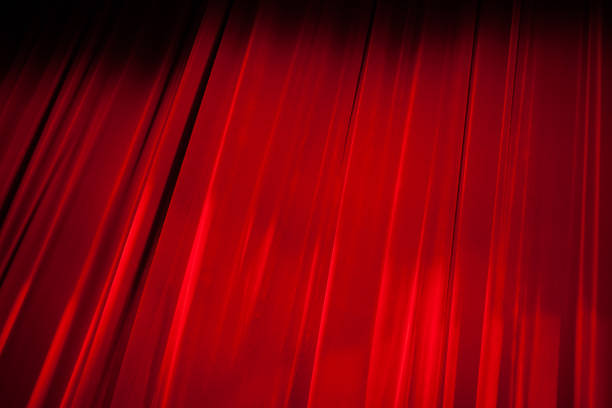 istock Light Shining on the Red Stage Curtain 866826258
