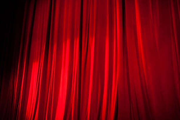istock Light Shining on the Red Stage Curtain 866826278