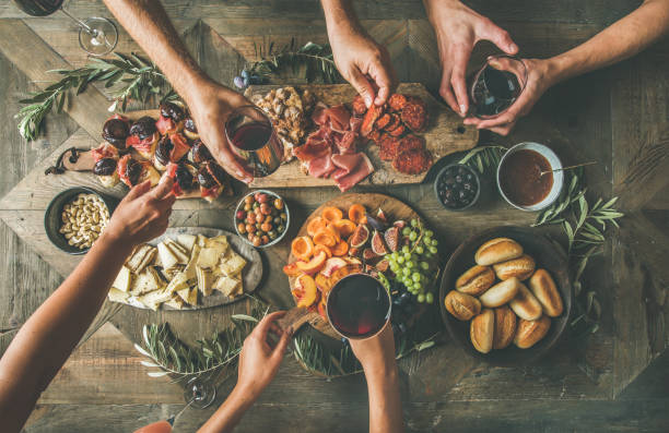 istock Top view of people drinking and eating together over table 866826944