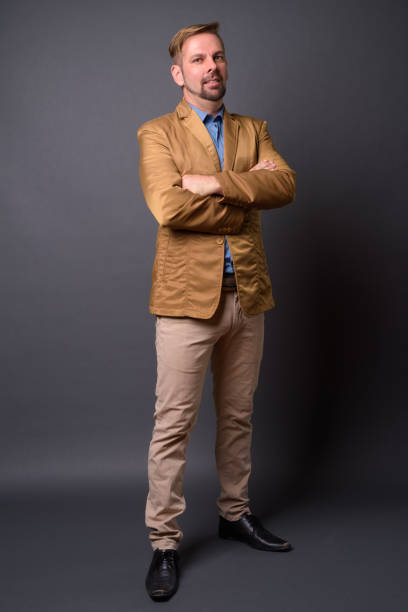 istock Blond goatee bearded businessman wearing brown suit against gray background 866841428