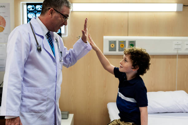 istock Young patient boy giving a doctor hi five 866841444