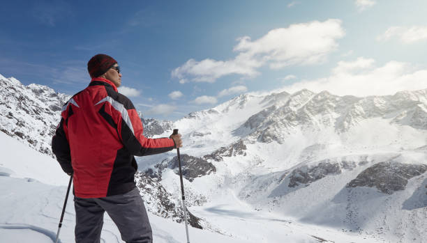 istock Climber looking at a snowy mountain landscape in a sunny winter day. 866849766