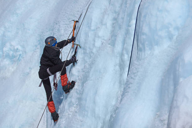 istock An ice climber makes his way on a frozen waterfall 866849994