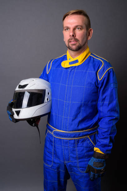 istock Blond goatee bearded man motorcyclist in full gear against gray background 866853388