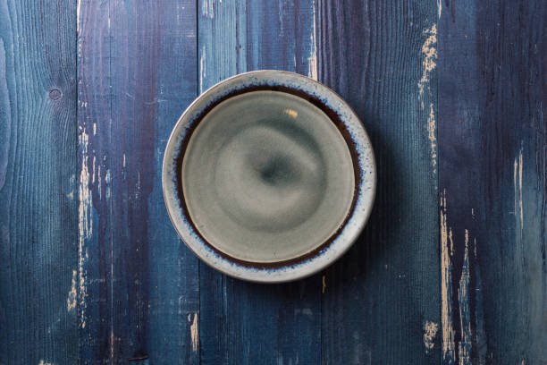 istock Plate on blue wooden background 866859510