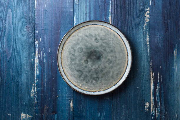 istock Plate on blue wooden background 866859660