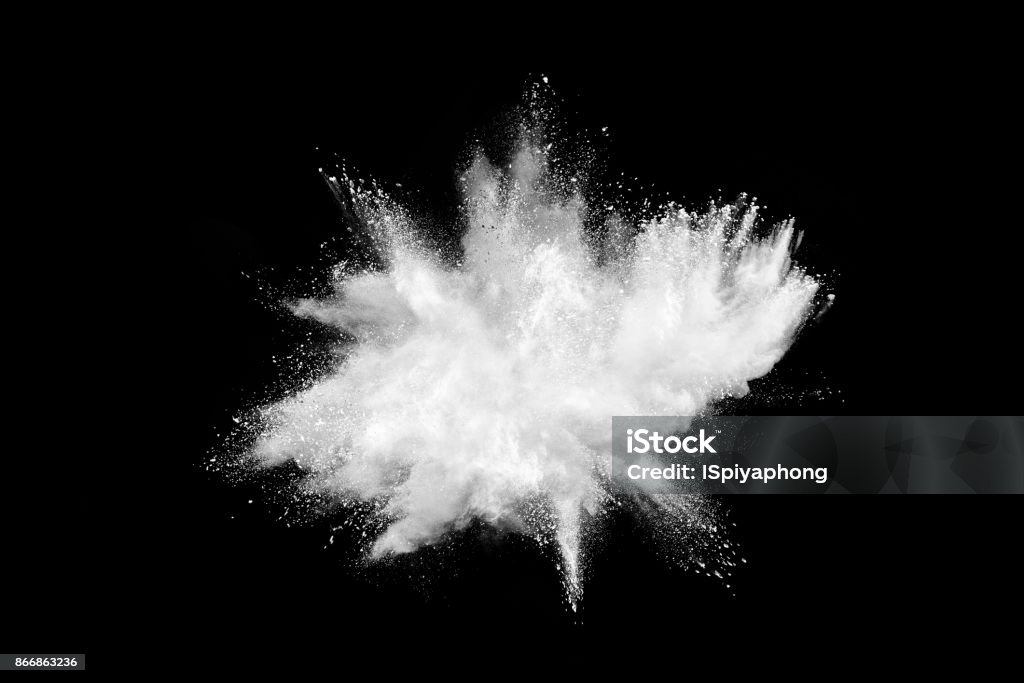 Freeze motion of white powder explosions isolated on black background Ground - Culinary Stock Photo