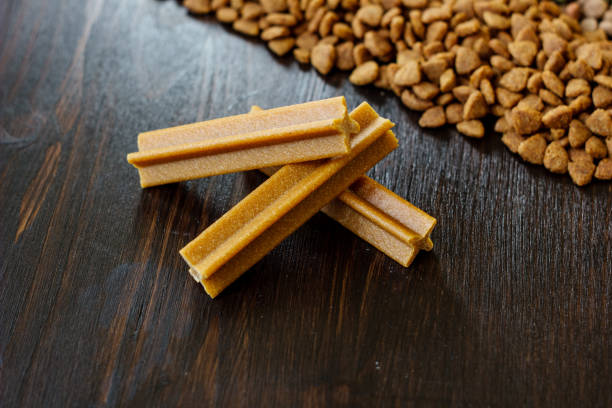 istock Dry pet food on black wooden table. 866863478