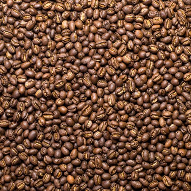 Flay lay style, Medium dark Roasted peaberry coffee beans on bamboo handcraft background.