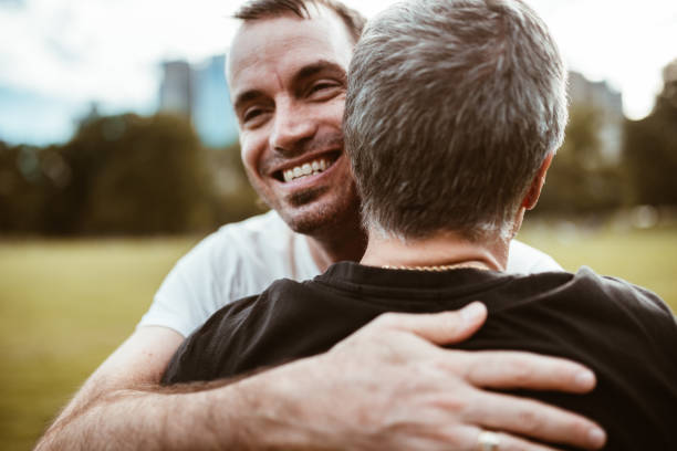 istock gay couple embracing in central park 866876174