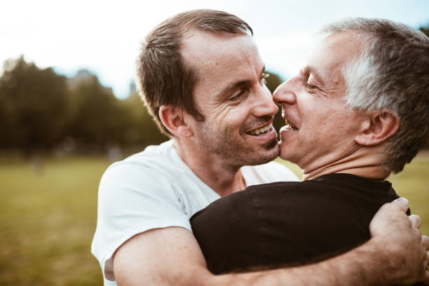 istock gay couple embracing in central park 866876248