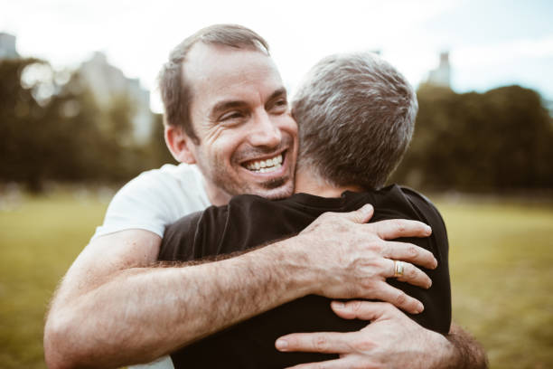 istock gay couple embracing in central park 866876596