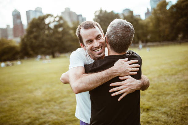 istock gay couple embracing in central park 866876648