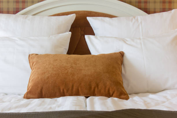 istock Pillows on bed in hotel room. White and brown one. 866876696