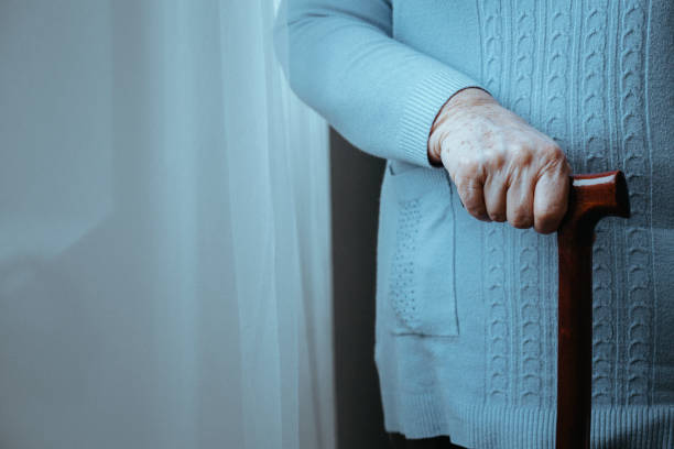 istock Senior person with wooden cane 866882654