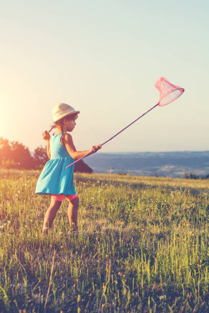 istock Girl chasing a butterfly 866886070