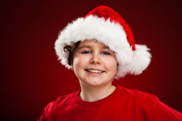 istock Christmas time - boy with Santa Clause hat 866886652
