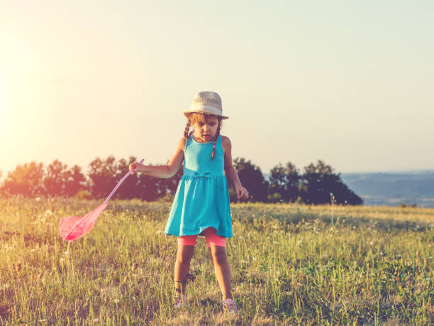istock Girl chasing a butterfly 866887652