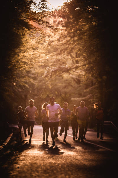 istock Group of athletes taking part in marathon race at sunset. 866887702