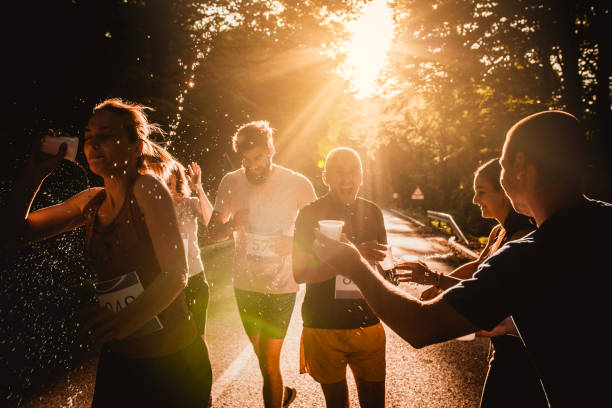 istock Athletic people taking fresh water from volunteers during marathon race at sunset. 866890534