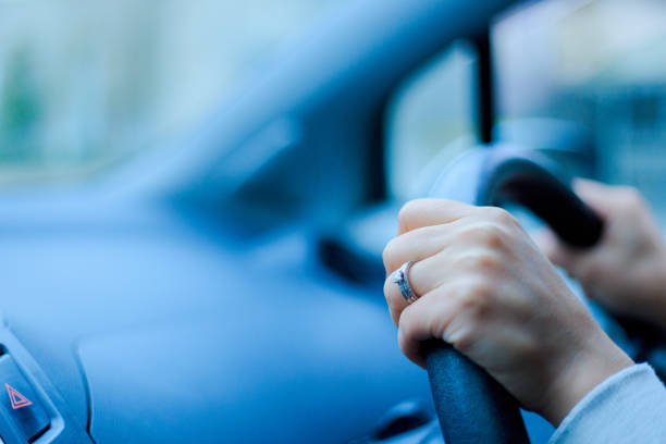 Close-up of a woman's hand holding a car handle
